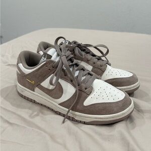 Nike Low-Top Sneakers in White and Taupe with Gold Swoosh